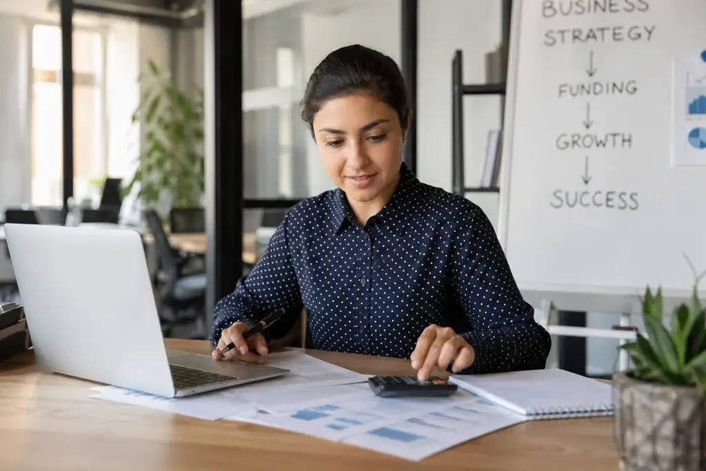 woman working on laptop reviewing documents